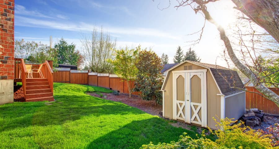 Fenced backyard with storage shed in Long Island